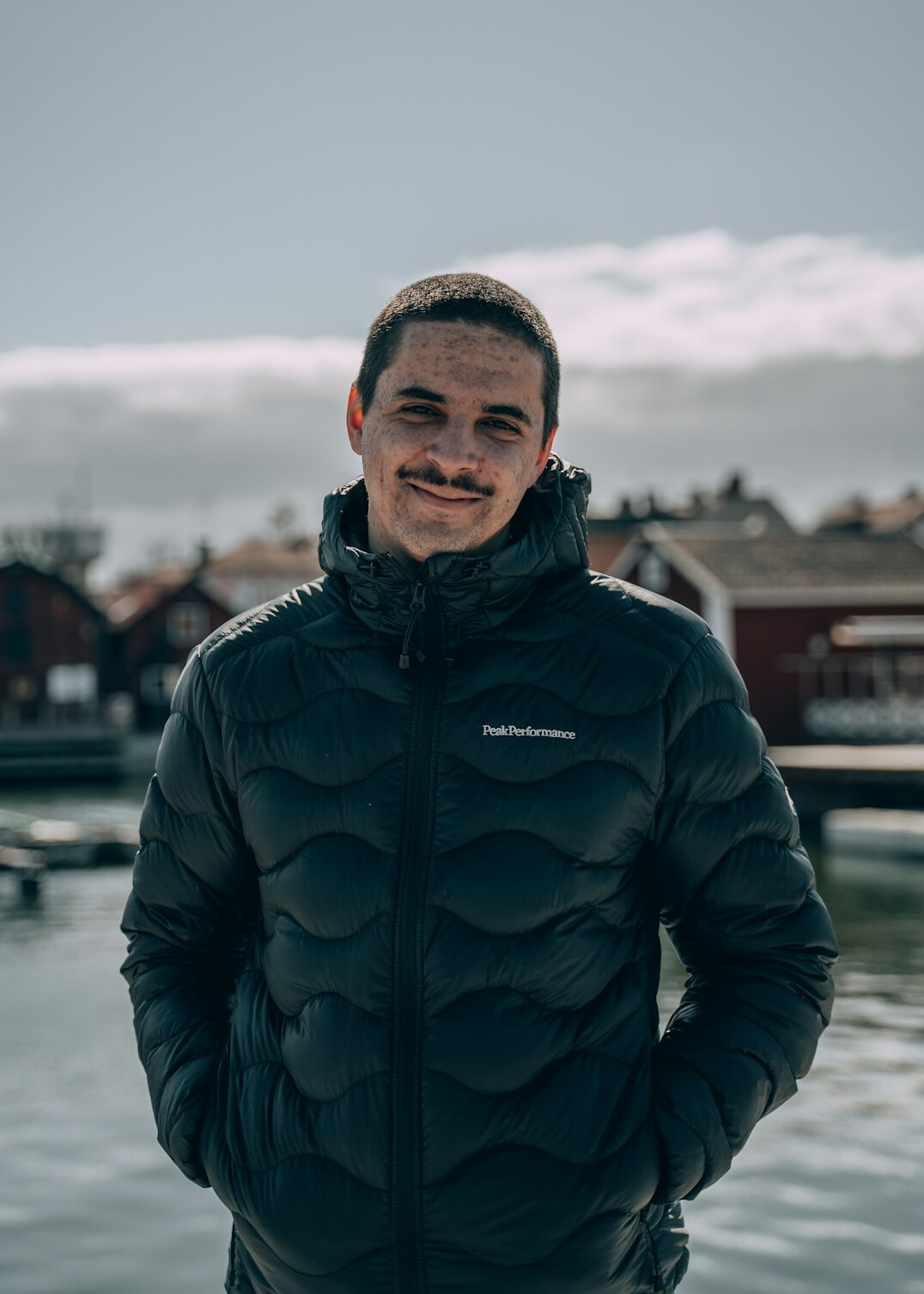 Portrait of a smiling man in a dark jacket